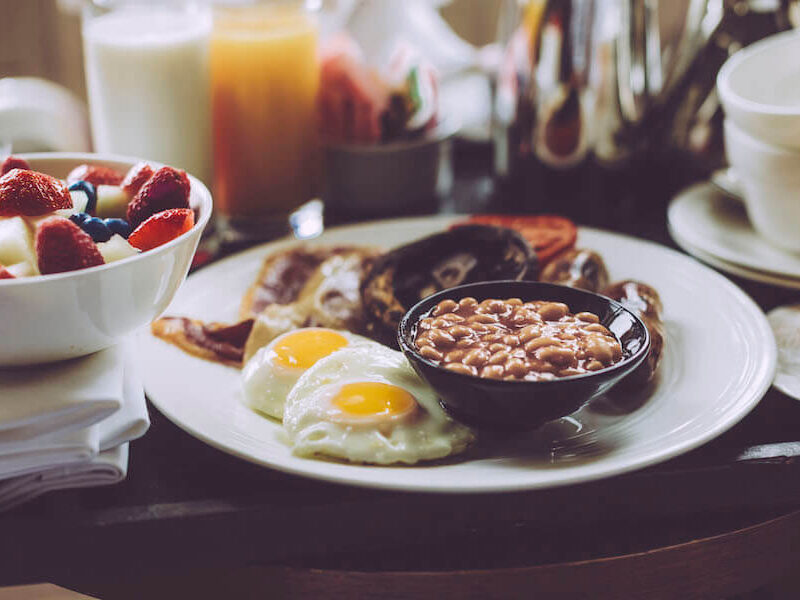 Gourmet breakfast with eggs, fresh oven-baked beans and berries